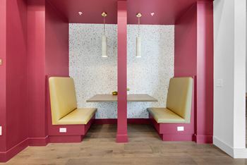 a pink waiting room with two yellow chairs and a table at The Enclave at Deer Moss Creek, Florida